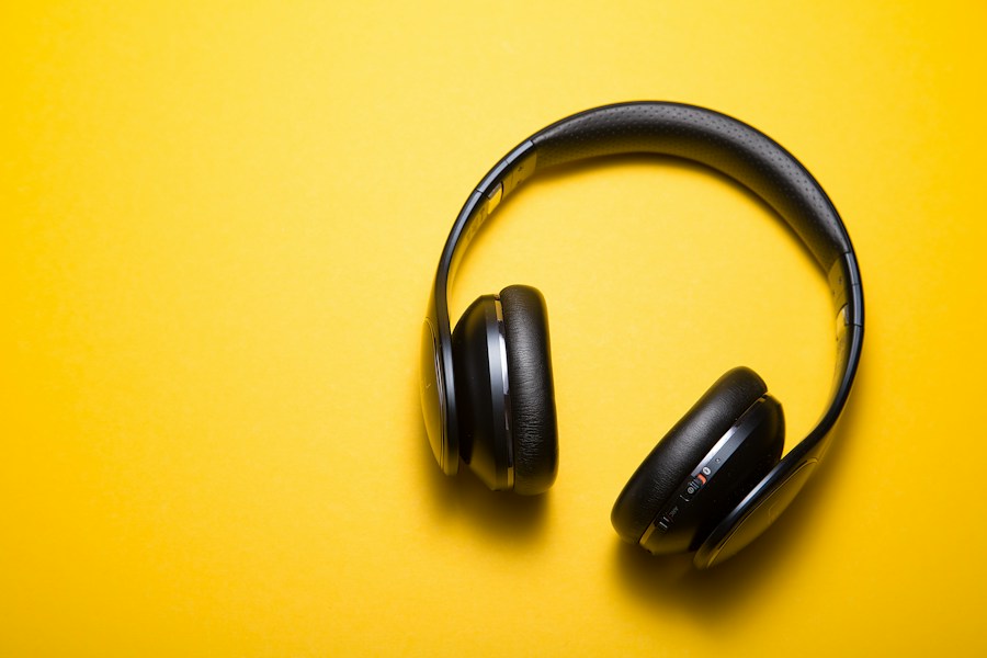 Black headphones on a sunny yellow background